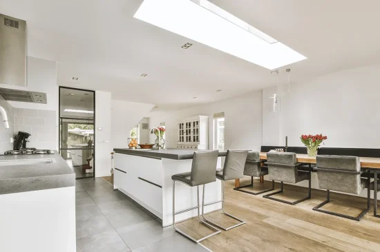 Side-return kitchen extension with skylights and white cabinetry